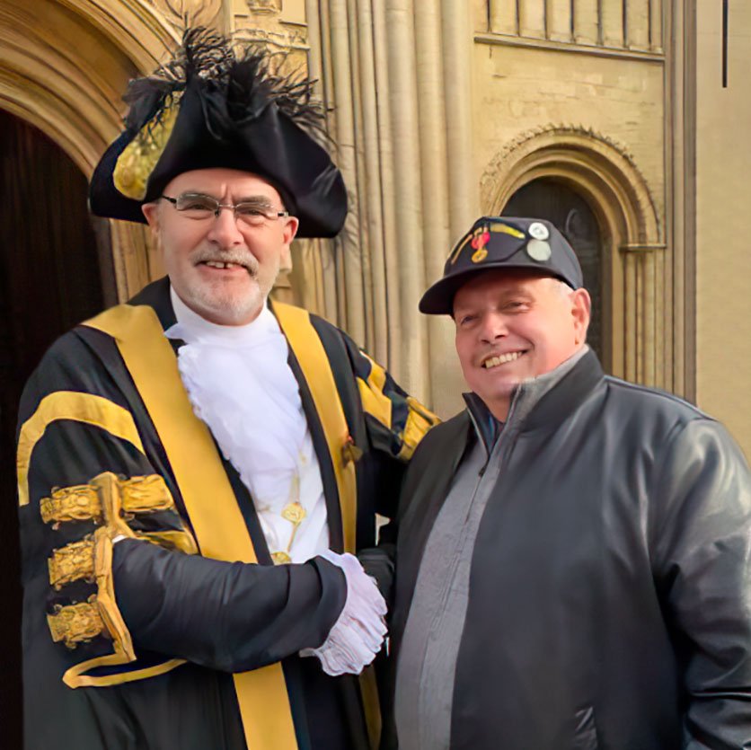 J Birmham shaking hands with unknown person